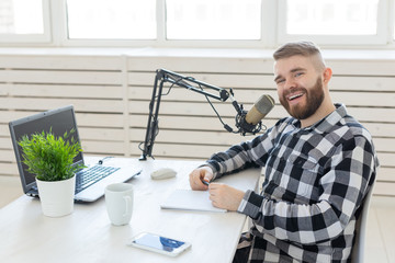 Radio host concept - Side view of handsome man working as radio host at radio station