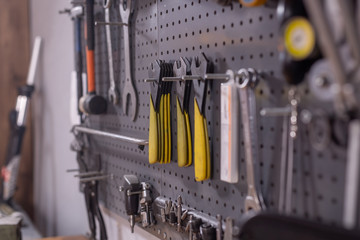 Set of tools, screws, pliers and nuts on a workshop background