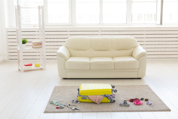 Trip, travel and holidays concept - packs a suitcase for the trip