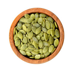 pumpkin seeds in wooden bowl isolated on white background