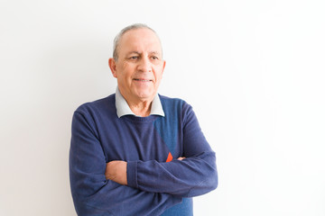 Handsome middle age senior man smiling cheerful, happy and positive leaning over white background with crossed arms