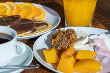 Breakfast of many dishes and drinks on a wooden table, closeup. Food concept