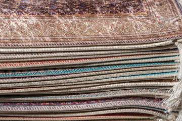 Traditional carpets for sell at a street market stall in Bodrum, Turkey. Closeup