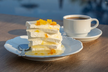 Curd cheese with lemon jam and cup coffee on table. Breakfast concept