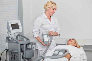 kind friendly therapist talking with a client during procedure. close up photo