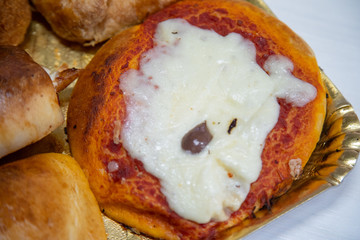 Sicilian Cartocciata, Pizzetta, Cipollina and Arancino. A typical street food from Sicily.