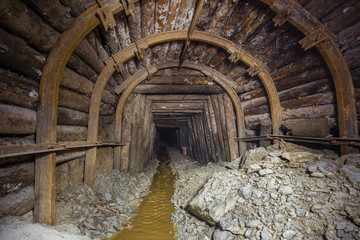Fototapeta na wymiar Gold ore mine shaft tunnel underground wood timbering