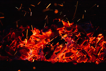 red burning charcoal with sparks and flames