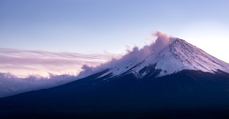 Fuji volcano mountain coverd with snow and cloud in sunset.