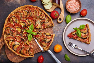 Quiche open tart pie with chicken meat, tomatoes, eggplant and cheese. Savory taste