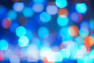 Abstract blue bokeh lights background. Blurred colored lights garlands. Beautiful Christmas and New Year background.