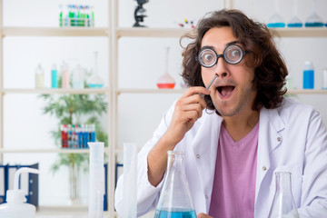 Funny male chemist working in the lab