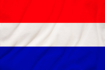 national flag of the country Holland on gentle silk with wind folds, travel concept, immigration, politics, copy space, close-up