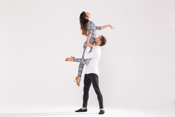 Social dance, kizomba, tango, salsa, people concept - beautiful couple dancing bachata on white...