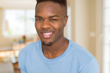 Obraz premium Handsome african young man smiling cheerful with a big smile on face