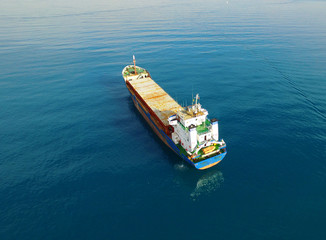 cargo container ship traveling in water | High Level Bird Eye Shot