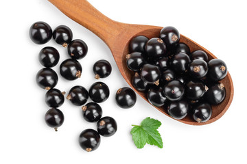 Black currants in spoon on white background.Top view. Flat lay pattern
