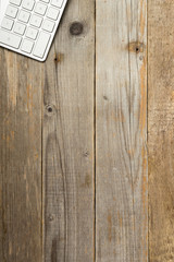 white computer keyboard on weathered wooden table, directly above