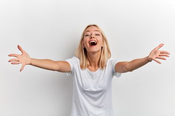 Portrait of a happy cheerful attractive young girl with outstretched hands going to embrace friend isolated on a white background, friendship, love - obrazy, fototapety, plakaty