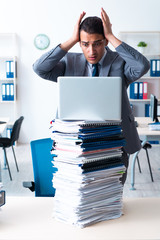 Businessman with heavy paperwork workload