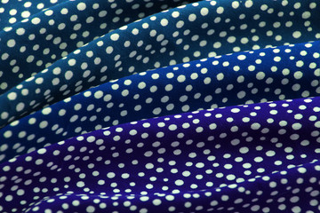 beautifully draped with soft folds bright green, blue, fabric for needlework or decor, polka dot...