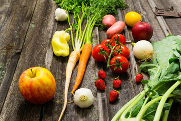 fresh fruits and vegetables on old weathered wooden
