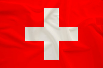 national flag of switzerland on delicate silk with wind folds, travel concept, immigration, politics