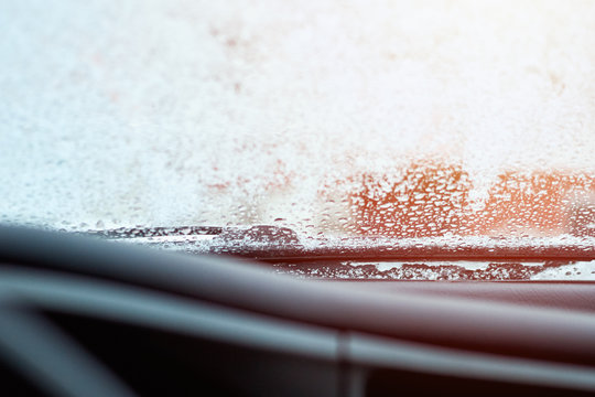  Close up of car windshield and wipers covered with ice and snow on winter day