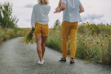 Obraz premium Calm young parents walking on the road outdoors