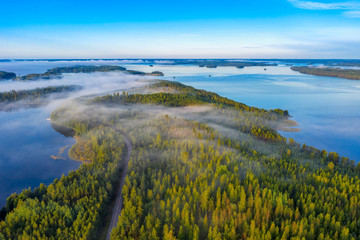 Aerial view of Pulkkilanharju Ridge, Paijanne National Park, southern part of Lake Paijanne. Landscape with drone. Blue lakes, fields and green forests from above on a sunny summer day in Finland.