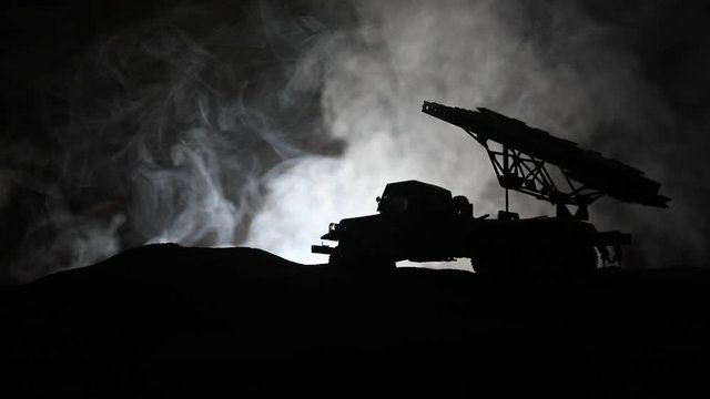 Rocket launch with fire clouds. Battle scene with rocket Missiles with Warhead Aimed at Gloomy Sky at night. Soviet rocket launcher on War Background. Creative composition.