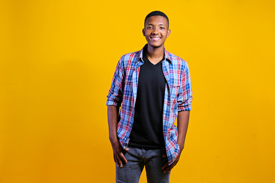 Young handsome man of african american ethnicity wearing checkered shirt posing over isolated background. Portrait of stylish confident male in casual outfit. Close up, copy space. - Powered by Adobe