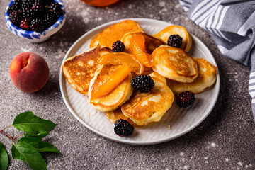 Pancakes with apricot jam and berry