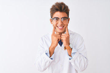 Young handsome sciencist man wearing glasses and coat over isolated white background Smiling with open mouth, fingers pointing and forcing cheerful smile