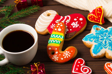 Cup of coffee and christmas cookies , gingerbread and toys on wooden table.