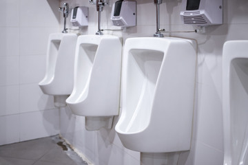 Automatic white ceramic urinals in public toilet