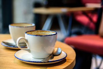 Two empty cups of coffee on cafe table