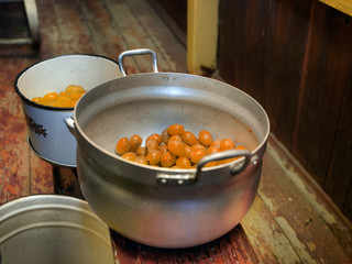 Making  plum jam in a kitchen