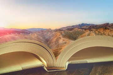Beautiful dreamy landscape at sunrise on the pages of an open book. Reading, literacy, imaginary, education, story, travel concepts. © Matthieu