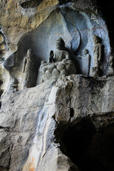 Fototapeta na wymiar buddha statue carved in natural rock inside a cave in china
