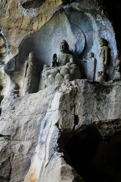 buddha statue carved in natural rock inside a cave in china