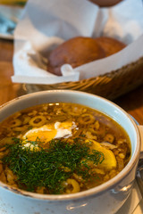 Borscht or borsht soup in a rustic bowl with sour cream and dill