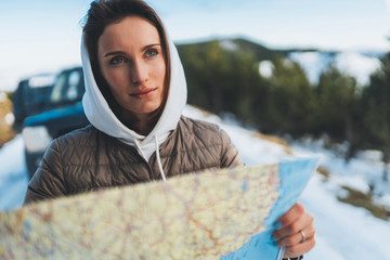 portrait girl hold in hands looking on map, relax tourist travels by auto car, people planning trip in snow mountain, hipster enjoy winter nature, journey landscape trip, lifestyle holiday concept