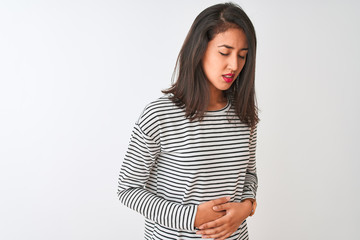 Obraz premium Young beautiful chinese woman wearing striped t-shirt standing over isolated white background with hand on stomach because nausea, painful disease feeling unwell. Ache concept.