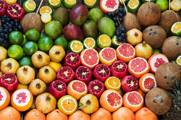 Background of fresh fruit in the market. Orange pomegranate grape lime coconut mango grapefruit.