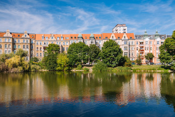 Fototapeta na wymiar Kasprowicz Park in Szczecin. View of the surrounding historic tenement houses. landscape
