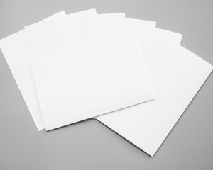 Poster mock-ups paper, white paper isolated on gray background, Blank portrait A4. brochure magazine isolated on gray, can use banners products business texture background for your.