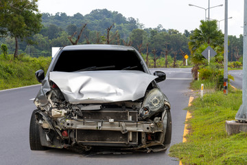 Front of light gray car big damaged and broken by accident on city street parking can not drive any...