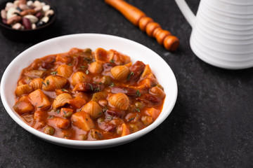 Vegetable grains peas soup in tomato sauce