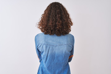 Young brazilian woman wearing denim shirt standing over isolated white background standing...